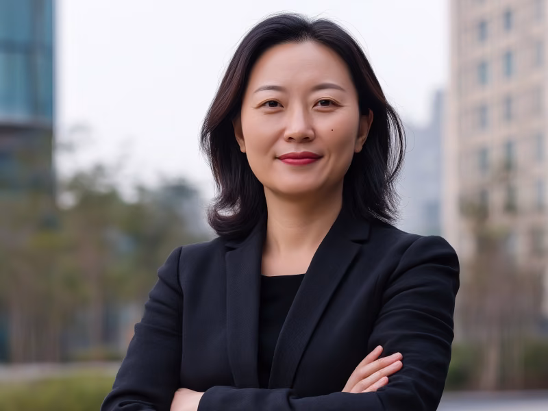 Professional woman smiling with arms crossed