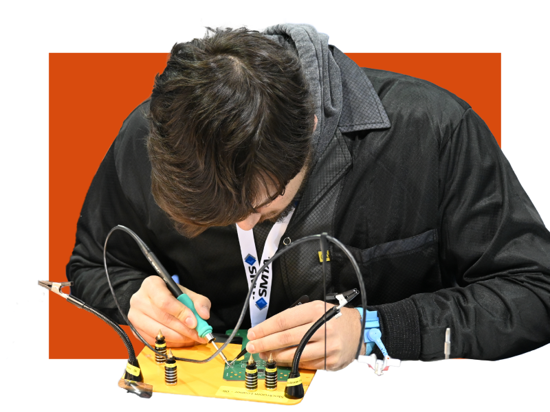 Student soldering a printed circuit board