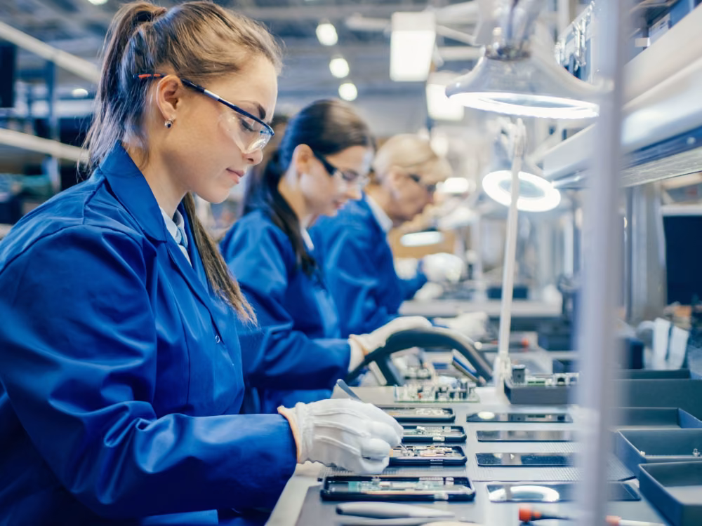 Electronics Manufacturing workers with circuit boards